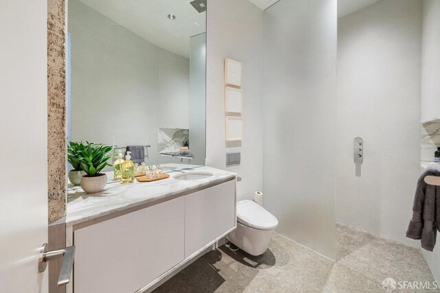 bathroom featuring vanity and toilet