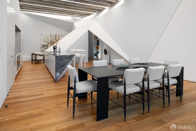 dining space featuring light hardwood / wood-style flooring and sink