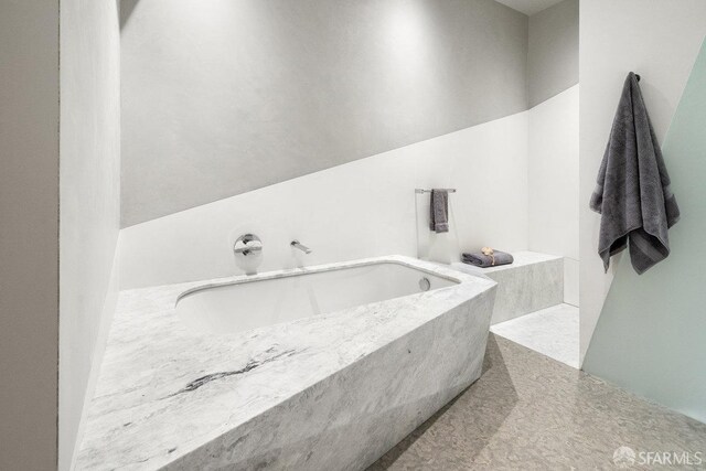 bathroom with a tub to relax in