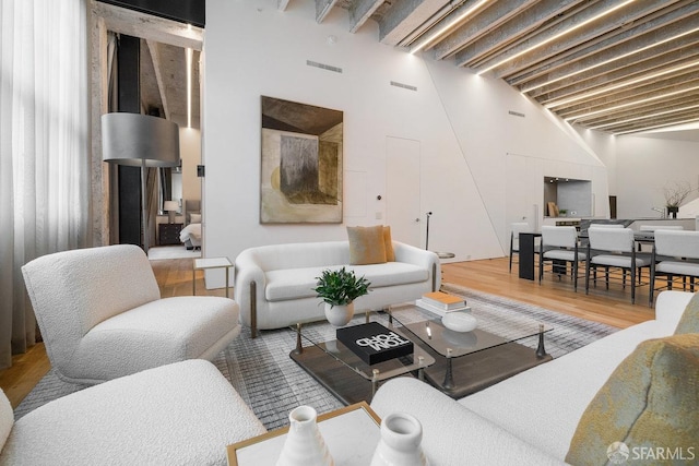 living room featuring hardwood / wood-style floors and a high ceiling