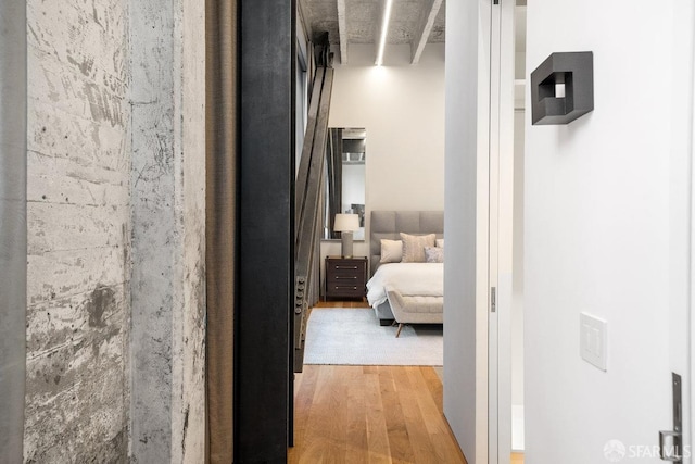 hall with beam ceiling and light hardwood / wood-style flooring