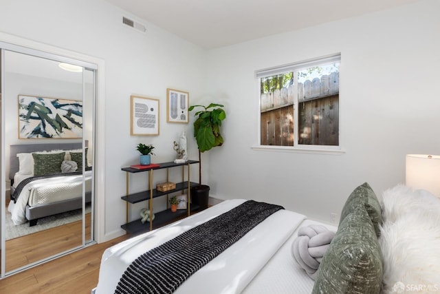 bedroom featuring wood-type flooring and a closet