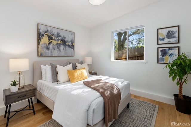 bedroom with hardwood / wood-style floors