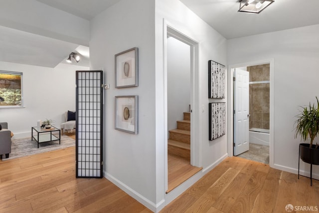 corridor with light hardwood / wood-style floors