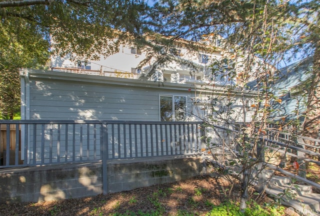 rear view of house featuring a deck