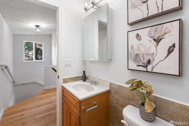 bathroom featuring vanity, hardwood / wood-style floors, and toilet