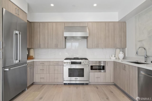 425 First St Unit 31, Los Altos, CA 94022 - kitchen featuring high end appliances, wall chimney range hood, light brown cabinetry, modern cabinets, and recessed lighting