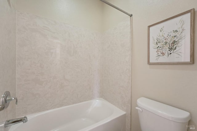 bathroom featuring shower / bathing tub combination and toilet