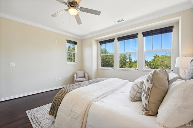 bedroom featuring ceiling fan, crown molding, multiple windows, and wood-type flooring