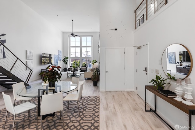 229 8th St Unit 3, San Francisco, CA 94103 - dining room with a high ceiling, light wood-type flooring, ceiling fan, and stairway