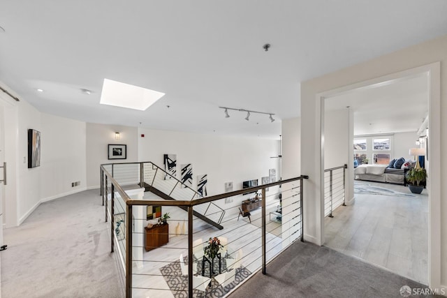 229 8th St Unit 3, San Francisco, CA 94103 - corridor featuring an upstairs landing, a skylight, and light carpet