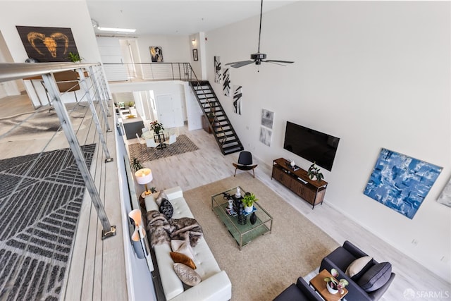 229 8th St Unit 3, San Francisco, CA 94103 - living room featuring wood finished floors, a ceiling fan, and a high ceiling