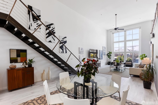 229 8th St Unit 3, San Francisco, CA 94103 - dining area with a towering ceiling, light wood-type flooring, stairway, and ceiling fan
