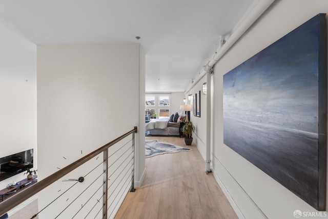 229 8th St Unit 3, San Francisco, CA 94103 - hallway featuring light wood-type flooring and an upstairs landing