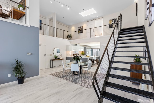 229 8th St Unit 3, San Francisco, CA 94103 - stairs featuring a high ceiling, a skylight, and wood finished floors
