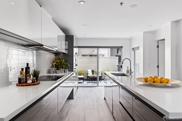 229 8th St Unit 3, San Francisco, CA 94103 - kitchen featuring modern cabinets, black electric cooktop, decorative backsplash, light countertops, and recessed lighting