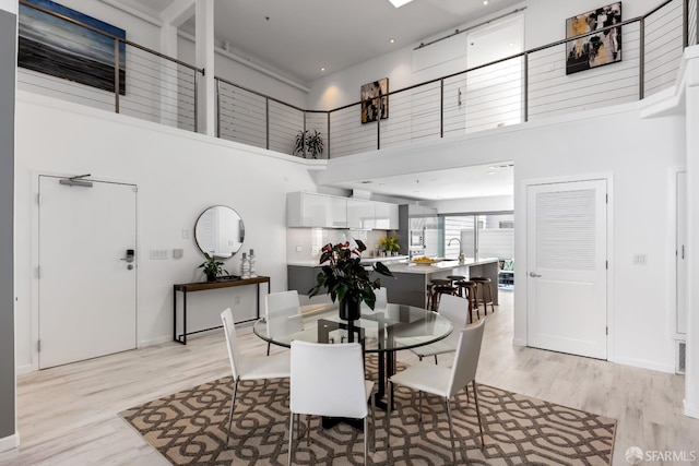 229 8th St Unit 3, San Francisco, CA 94103 - dining space featuring a high ceiling and light wood-style flooring