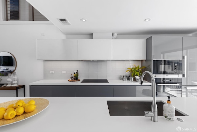 229 8th St Unit 3, San Francisco, CA 94103 - kitchen with stainless steel appliances, modern cabinets, tasteful backsplash, light countertops, and white cabinetry