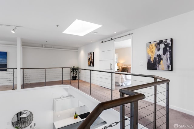 229 8th St Unit 3, San Francisco, CA 94103 - hallway featuring a skylight, an upstairs landing, carpet floors, recessed lighting, and track lighting