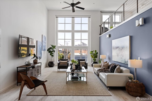 229 8th St Unit 3, San Francisco, CA 94103 - living room with a towering ceiling, a ceiling fan, and wood finished floors