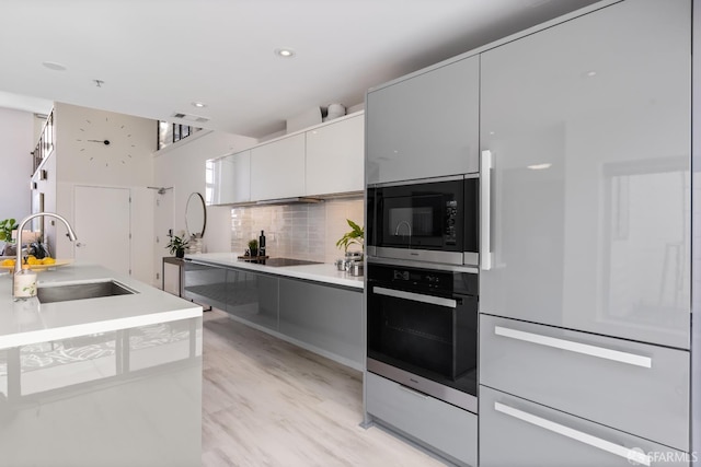 229 8th St Unit 3, San Francisco, CA 94103 - kitchen featuring wall oven, paneled fridge, modern cabinets, stainless steel microwave, and decorative backsplash
