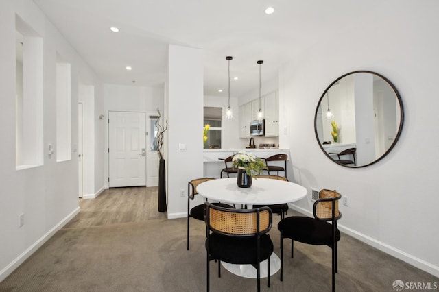 dining room with light colored carpet