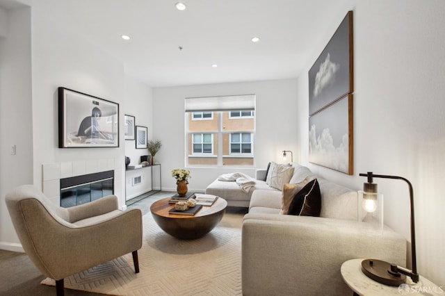 living room featuring a tiled fireplace