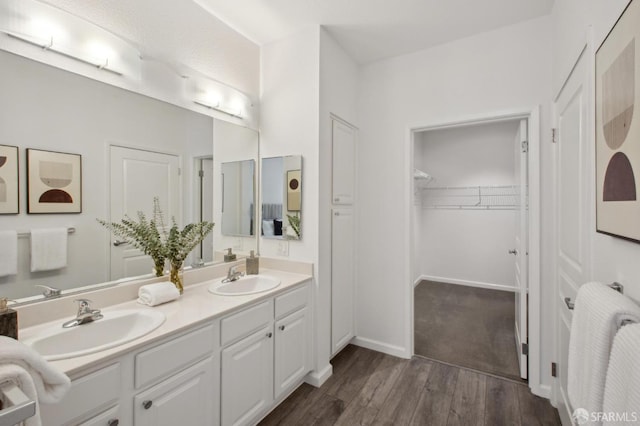 bathroom featuring vanity, radiator, and wood-type flooring