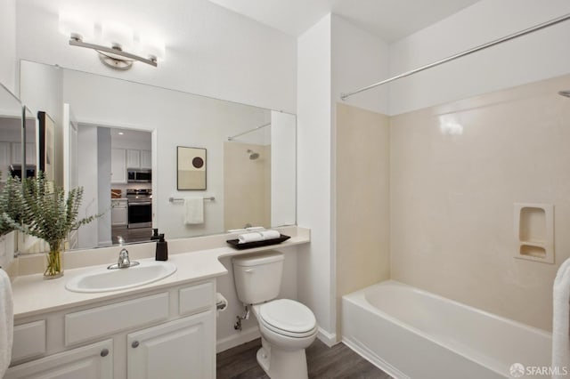 full bathroom with vanity, wood-type flooring, shower / bathing tub combination, and toilet