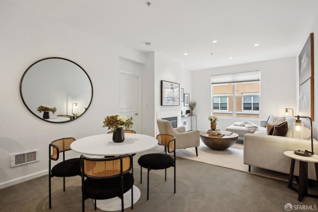 dining area with dark colored carpet