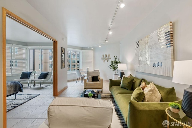 tiled living room featuring track lighting