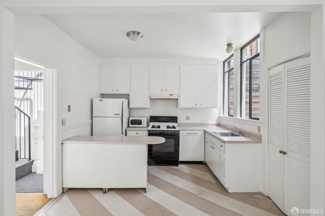 28-30 Sonoma St, San Francisco, CA 94133 - kitchen with white appliances, under cabinet range hood, a sink, white cabinets, and light countertops