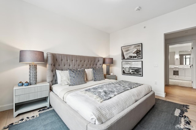 bedroom featuring wood-type flooring and ensuite bathroom