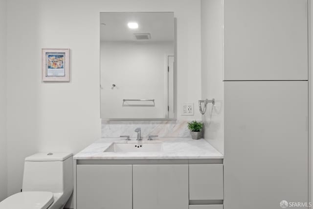 bathroom with toilet and vanity