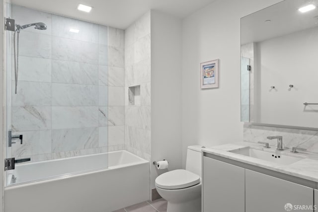 full bathroom with toilet, vanity, tiled shower / bath combo, and tile patterned flooring