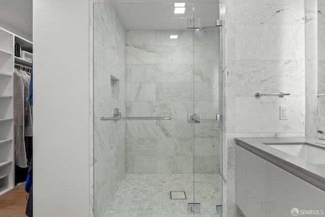 bathroom with an enclosed shower and vanity