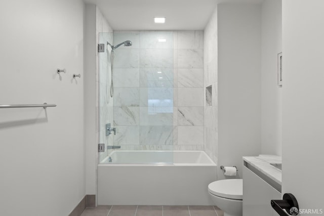 full bathroom featuring toilet, vanity, tiled shower / bath, and tile patterned flooring