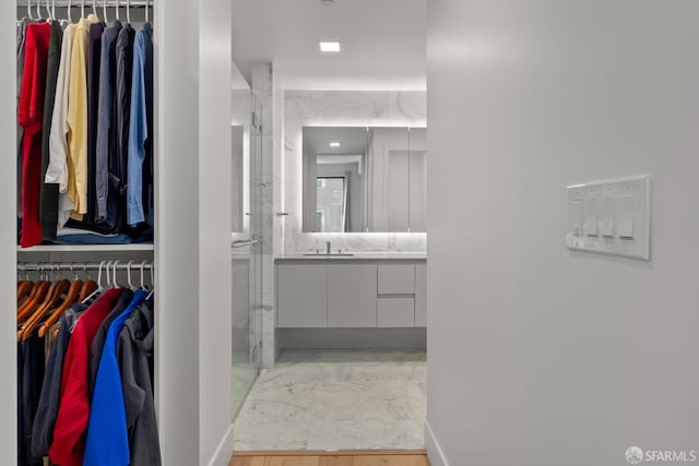 bathroom with an enclosed shower and vanity