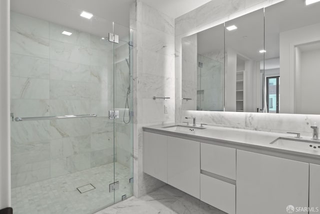 bathroom featuring vanity and a shower with door