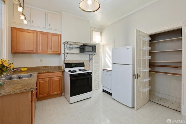 kitchen with a sink, white appliances, and ornamental molding