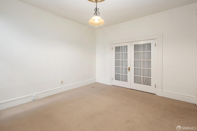 unfurnished room with french doors, carpet flooring, and baseboards