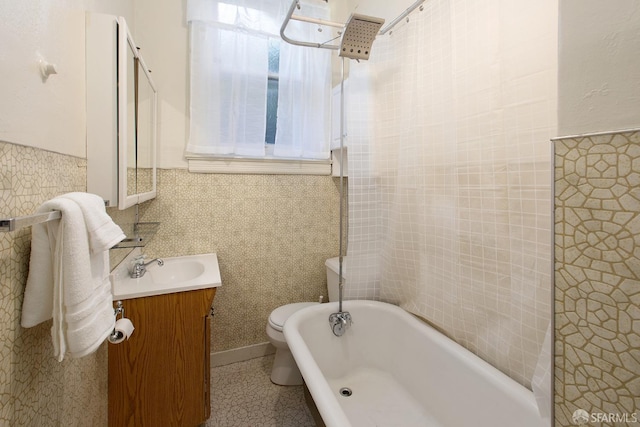 full bath with tile walls, a wainscoted wall, vanity, and toilet