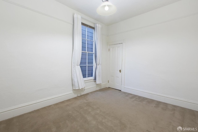 spare room with carpet floors and baseboards