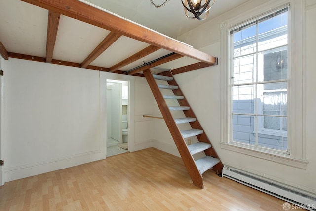 stairway featuring beam ceiling, wood finished floors, baseboards, a baseboard heating unit, and an inviting chandelier