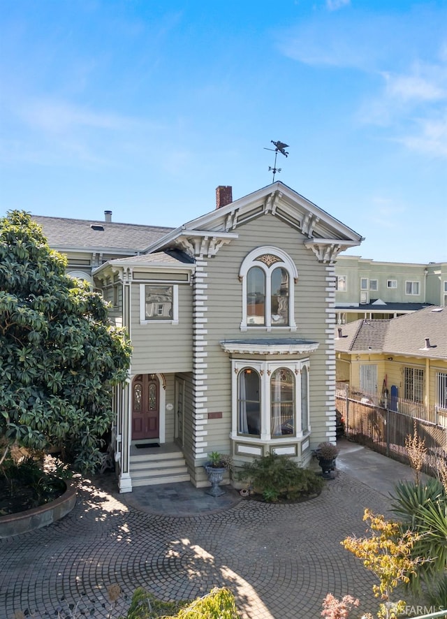 italianate house with fence and a chimney