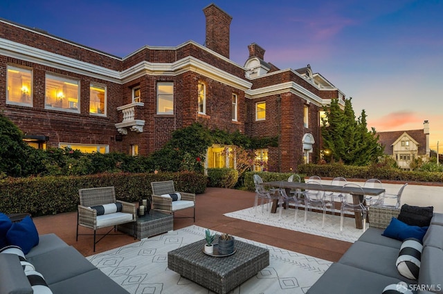 patio terrace at dusk featuring an outdoor living space and outdoor dining area