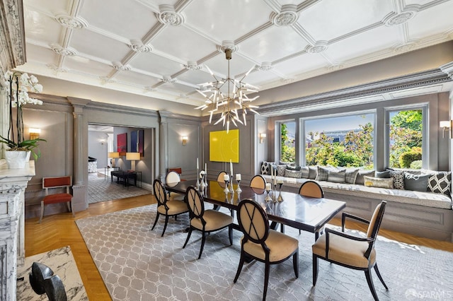 dining space with a notable chandelier, an ornate ceiling, and ornate columns