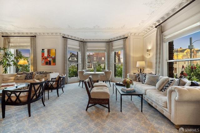 living room with crown molding, carpet flooring, and a wealth of natural light