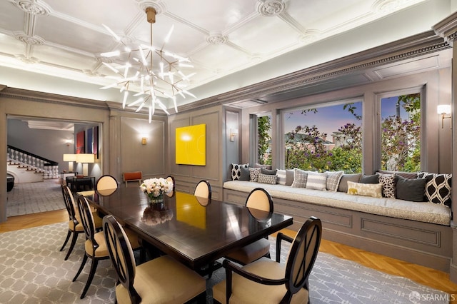 dining area with stairway, a chandelier, crown molding, and a decorative wall