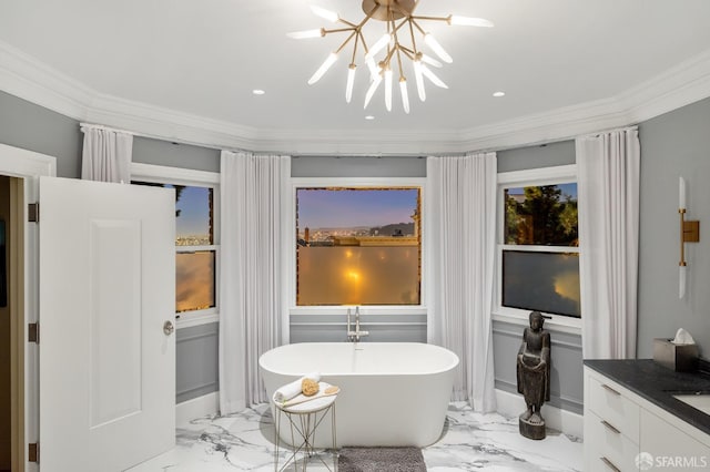 bathroom with a soaking tub, crown molding, marble finish floor, and a chandelier